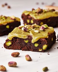 chocolate brownies with pistachios and frosting on top