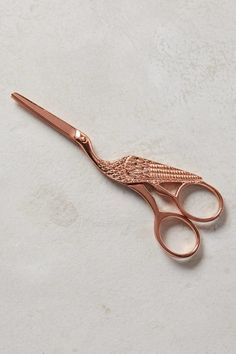 a pair of pink scissors sitting on top of a table