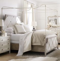 a bedroom with a white bed, dresser and mirror in it's center area