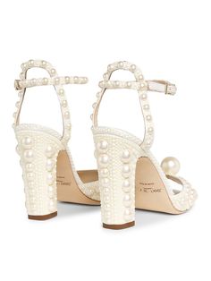 "Find JIMMY CHOO Sacora 100mm Pearl-embellished Sandals on Editorialist. Jimmy Choo's Sacora sandals are crafted of satin with ruched details. The peep-toe pair features faux pearl embellishments and a stiletto heel. Satin upper Peep toe Adjustable ankle closure Leather lining Leather sole Made in Italy SIZE & FIT This brand fits slightly smaller. Consider ordering a half size up. Self-covered stiletto heel, 4\" (100mm) ABOUT THE BRAND Jimmy Choo began as a made-to-order shoe boutique in London' Jimmy Choo Sacora, Embellished Sandals, Shoe Boutique, Thick Heel, Thick Heels, Brand Designer, Stiletto Heel, Jimmy Choo, Faux Pearl