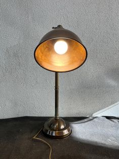 a lamp that is sitting on top of a table with a light bulb on it