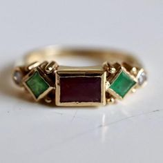 Named in homage to the artist and goldsmith, this design features a garnet, emeralds and 0.11 carats of diamonds accents mounted in a renaissance style setting. 14k gold - available in sizes 5-8. Yellow Gold Multi-stone Emerald Birthstone Ring, Heirloom 14k Gold Multi-stone Diamond Ring, Heirloom Multi-stone Diamond Ring In 14k Gold, Fine Jewelry Multi-stone Emerald Diamond Ring, Diamond Multi-stone Emerald Ring For May Birthstone, Heirloom Multi-stone Emerald Cut Diamond Ring, 14k Gold Multi-stone Emerald Cut Diamond Ring, Heirloom Multi-stone Diamond Ring With Emerald Cut, Heirloom Multi-stone Emerald Cut Ring