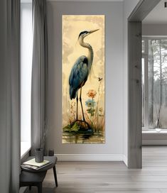 a painting of a blue heron on a wall next to a chair in a living room