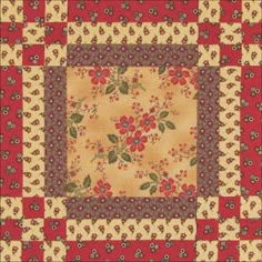 a red and yellow quilt with flowers on it