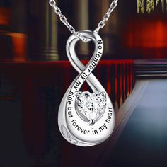 The Infinity Urn Necklace is a poignant symbol of eternal love and dedication. Featuring an infinity symbol, this necklace is a heartfelt way to honor and remember your loved ones. Engraved with the touching message, "No longer by my side, but forever in my heart," it provides comfort by keeping your dear ones close to your heart. Cremation Jewelry: This heart-shaped small urn is crafted from high-quality 925 sterling silver, ensuring it is hypoallergenic, tarnish-resistant, and free from nickel Meaningful Silver Infinity Jewelry, Meaningful Infinity Jewelry For Anniversary, Inspirational Silver Jewelry For Anniversary, Infinity Engraved Necklaces For Anniversary, Engraved Infinity Necklace For Anniversary, Anniversary Engraved Infinity Necklace, Small Urns, Urn Necklace, Urn Necklaces