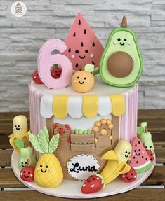 a cake decorated with fruits and vegetables on a table