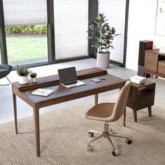 a desk with a laptop on it and a chair in front of the desk is shown