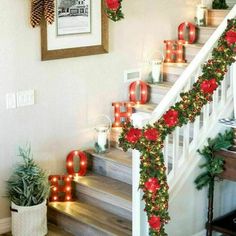 christmas decorations on the banisters and stairs are decorated with red poinsettias