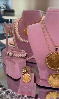 some pink and gold jewelry on display in a store