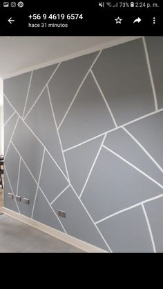 a room with grey and white wallpaper on the walls next to a dining table