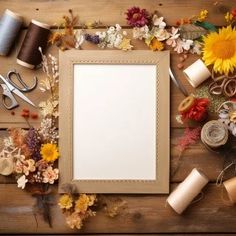 an assortment of crafting supplies including yarn, scissors and paper on a wooden table