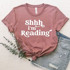 This simple bookish t-shirt is fun, trendy, and perfect for any occasion! Our super soft tees make the perfect gift for book lovers, any introvert in your life, or yourself because you're awesome and deserve it! 🤍 If you're looking for something specific send me a message and we can make it happen! TEE SIZING/INFO: * Available in sizes XS-3XL * These are Unisex tees! Women may prefer one size smaller than usual. * Please refer to our size chart for measurements! * Bella + Canvas Shirt, pre-shru Bookish Shirt Designs, Book Lovers Shirts, Book Themed Shirts, Reading Tshirt Ideas, Bookish Cotton T-shirt With Letter Print, Bookish Cotton T-shirt With Slogan, Bookish Short Sleeve T-shirt With Funny Text, Bookish Crew Neck T-shirt With Letter Print, Bookish T Shirts