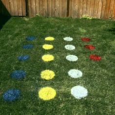 a yard with colored circles on the grass and a wooden fence in the back ground