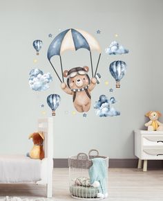 a child's bedroom with a teddy bear flying through the sky on a hot air balloon