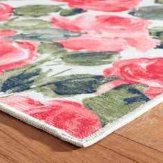 an area rug with red flowers on it