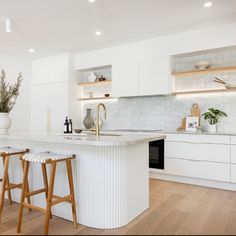 two stools are in front of the kitchen island