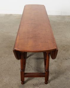 an old wooden table with curved legs