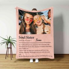 two girls with their faces covered by a pink blanket that says, soul sister flora