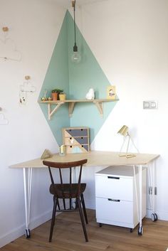 a room with a desk and shelves on the wall