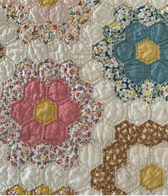 a close up of a quilt with flowers on it