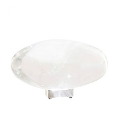 an oval glass table top on a metal stand against a white background with the light reflecting off it's surface