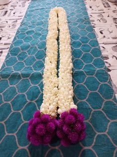 two white and purple flowers on a blue mat