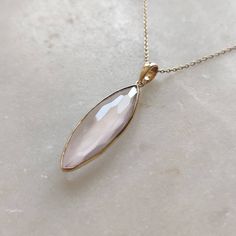 ITEM DESCRIPTION: >>The pendant is made from Solid 14K Yellow Gold. Gemstone used is absolutely natural and ethically sourced. >>Natural Rose Quartz in briolette cut and Marquise shape with bezel setting is studded on it with utmost precision. >>This is a minimalist design and is absolutely hassle-free and everyday jewelry. Gem: Rose Quartz Gem size: 10x25 mm Marquise Gem weight: 8.05 carats Gold purity: 14K (58.33% approx.) Gold weight: 0.60 grams Gross weight: 2.39 grams The Gold purity is gua Rose Gold Marquise Jewelry For Gifts, Elegant Pink Gold Jewelry With Bezel Setting, Rose Gold Teardrop Jewelry With Bezel Setting, Rose Gold Marquise Gemstone Jewelry, Marquise Gemstone Necklace For Gift, Rose Gold Drop Necklace With Gemstone, Rose Gold Drop Gemstone Necklace, Handmade Jewelry Box, Green Amethyst Ring