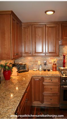 a kitchen with granite counter tops and wooden cabinets