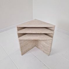 three shelves stacked on top of each other in the middle of a white tiled floor