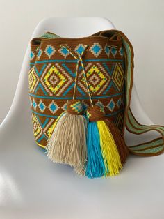 This is a handmade crochet shoulder bag made by the Wayuu tribe from Colombia. Is one thread weaven, made with ancestral wisdom and special meaning. It's said  every "mochila" chose its Owner... is this one for you? Take it to the beach, for a casual dressing shopping day , on your trips... it looks so hippie chic and everyone will talk about it 100% COTTON directly from the Wayu' community in Guajira  Colombia, with your purchase, we help the Wayuu people to its development and evolution. Appro Bohemian Crochet Travel Bag, Bohemian Crochet Travel Bag With Weaving, Bohemian Bucket Crochet Bag With Weaving, Bohemian Handwoven Bucket Bag, Bohemian Bucket Crochet Bag With Weaving Details, Bohemian Crochet Bucket Bag With Weaving, Bohemian Brown Crochet Bag With Woven Details, Bohemian Brown Woven Crochet Bag, Bohemian Natural Crochet Bucket Bag