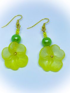 These are Yellow Pansy Flower Earrings with Green Pearl Beads and yellow glass seed beads for pierced ears. They feature gorgeous yellow acrylic pansy flower beads and also a green plastic pearl bead on each earring. They also feature gorgeous yellow glass seed beads.  These handmade earrings are 1.75 inches in length with a drop of 2.25 inches and they are set on gold coloured shepherds hooks and are suitable for people with pierced ears.  Please contact me if you would prefer clip ons. Check out my shop for lots of other gorgeous colours of these earrings and also bracelets and necklaces to complement them. Green Flower-shaped Earrings For Beach, Green Flower Earrings For Beach, Green Flower-shaped Beach Earrings, Beaded Flower Earrings With Czech Glass For Gifts, Beaded Czech Glass Flower Earrings Gift, Gift Flower Earrings With Beaded Czech Glass, Gift Beaded Flower Earrings With Czech Glass, Neon Yellow Drop Earrings As A Gift, Neon Yellow Jewelry For Summer Gift