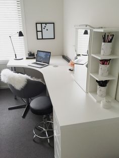 a white desk with a laptop computer on it