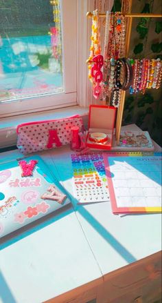 a table with many items on it near a window