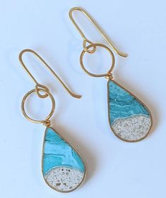 These lightweight teardrop dangle earrings, made from hand-colored eco-resin, feature a mix of crushed stones, silver specks, and real sand. The body and wiring are created with jewelers brass; for an additional cost, 14 K Gold Filled Ear Wiring is also available. The earrings measure 1.25" high and hang approximately 1.75" from the ear. For best results, each piece is handmade and crafted individually; slight variations of color and sand shapes should be expected. To maintain luster, please rem Teardrop Resin Jewelry, Unique Teardrop Resin Earrings, Resin Teardrop Earrings For Gifts, Eco Resin, Crushed Stone, Teardrop Dangle Earrings, Pouring Painting, Hand Coloring, Art Ideas