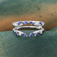 a wedding ring with blue and white stones