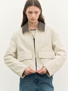 a.t.corner presents casual wear with a special feminine mood in a standard silhouette of unchanging value.- This is a trucker-style cotton jacket - Made with 10 count cotton twill material- The highlight of the collar color block is the zipper closure and outer pocket- This outerwear has canton buttons on the back of the sleeves and body Spring Workwear Outerwear With Corduroy Collar, Spring Utility Jacket With Corduroy Collar For Work, Cotton Utility Jacket With Corduroy Collar For Work, Classic Beige Outerwear With Corduroy Collar, Cotton Utility Jacket With Double-needle Sleeve For Work, Beige Cotton Outerwear For Spring, Spring Utility Jacket With Corduroy Collar, Beige Cotton Utility Jacket With Lapel Collar, Cream Cotton Utility Outerwear