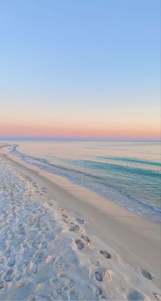 the beach is covered in white sand and footprints