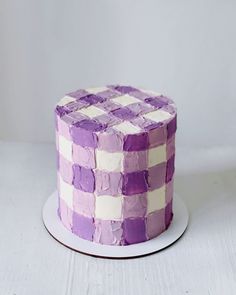 a purple and white cake sitting on top of a plate