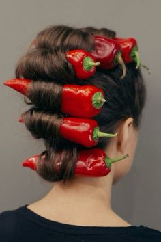 a woman with red peppers on her hair