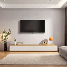 a living room with a flat screen tv mounted on the wall