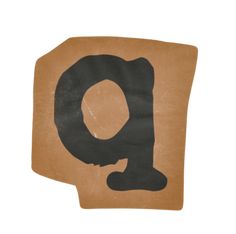 the letter q is made out of brown paper with black ink on it's surface