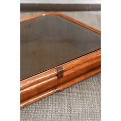 a wooden table with glass top on the floor