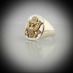 United States Army Eagle Bespoke Sterling Silver Ring with 9 carat gold emblem this is made in our Studio by our own skilled Silversmith Artisans. This ring will make the owner very proud to wear it is solid sterling silver with 9 carat gold emblem on top. We can laser any writing on each side of this ring or leave with nothing if preffered please send us a message with your order if you want to include any writing or an image must be in black and white. Remainder of ring is finished in high pol Classic 14k Stamped Signet Ring For Commemoration, Classic Hallmarked Signet Ring For Commemoration, Classic Hallmarked Engraved Ring For Commemoration, Classic Engraved Hallmarked Ring For Commemoration, Classic Polished Signet Ring For Commemoration, Classic 14k Gold Signet Ring Stamped 925, Classic Signet Ring For Commemoration, Classic Engraved Ring With Polished Finish For Commemoration, Silver 14k Gold Signet Ring For Commemoration