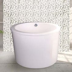 a white sink sitting next to a tiled wall