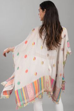 Brighten up your look with the Jacinda Kimono. This flamboyant design of multi-colored polka dots and a geometric patterned border is complete with snazzy eyelash fringe. Add a whimsical kimono to your collection this spring! Materials: 100% Cotton Size: 30" Long Made in India Multicolor Tassel Kaftan For Vacation, Spring Multicolor Kaftan With Tassels, Multicolor Tasseled Kaftan For Vacation, Multicolor Vacation Kaftan With Tassels, White Printed Kimono For Festival, Printed White Kimono For Festival, Multicolor Kimono With Tassels, Multicolor Kimono With Tassel Details, Bohemian White Kaftan With Tassels