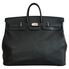 Gorgeous, authentic Hermes 55cm HAC Birkin. Black leather with chrome Palladium hardware, dual-belt turnstile lock closure. Above the closure on the lip of the bag is a monogram spelling "M.V.".  The blind stamp (Square G) on interior of right belt dates the bag to 2003. 55cm is the second-largest size of the HAC produced by Hermes. HAC is an abbreviation of " Haut à Courroies", or "high strap" in English. the HAC Birkin was first unveiled in 1892, and is the predecessor of the Birkin Bag. The H Big Hermes Bag, Luxury Everyday Bag In Togo Leather With Turn-lock Closure, Timeless Togo Leather Bag With Lock, Formal Togo Leather Bag With Lock, Office Togo Leather Bag With Lock, Formal Togo Leather Bag With Gold-tone Hardware, Luxury Togo Leather Travel Bag, Designer Togo Leather Bag For Everyday Use, Designer Togo Leather Bag