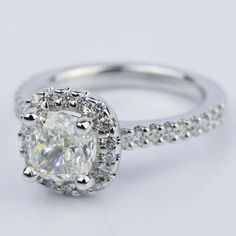 an oval cut diamond ring with pave set shoulders