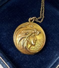 This is a gorgeous antique gold filled Victorian - Art Nouveau locket pendant necklace which features a beautiful goddess maiden woman with extraordinary flowing hair. This is one of the most beautiful images of a goddess woman we have seen on a locket. It is a sensitive romantic but strong depiction of womanhood! Her hair is magnificent as it swirls in the wind around her face. On the reverse is a fabulous initial monogram which I believe is MFH. The locket hangs from a fabulous gold filled chain. The locket and necklace are in wonderful condition. The necklace dates to circa 1890-1920. The locket opens to reveal places for two photos. The wonderful locket dances delightfully around the neck. Goddess maiden inspired jewels as well as lockets are all the rage today and finding one of this Art Nouveau Locket, Victorian Pendant Necklace, Enamel Locket, Hand Painted Necklace, Art Nouveau Pendant, Flowing Hair, Victorian Pendants, Most Beautiful Images, Beautiful Goddess