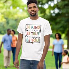 "In a world where you can be anything, be kind." (unknown). Introducing Your New Favorite T-shirt: Be Kind, Be Brave, Be True, Be Happy, Be You! Are you ready to embrace kindness, bravery, truth, happiness, and most importantly, yourself? Look no further! Our exclusive Be Kind t-shirt is here to make a statement while keeping you cozy and stylish.Crafted from 100% ring-spun cotton, this shirt is more than just a piece of clothing—it's a commitment to spreading positivity wherever you go. (Colors include polyester.) The soft, breathable fabric ensures all-day comfort, while the double stitching on the neckline and sleeves guarantees durability, making it your go-to choice for any occasion.But that's not all! Each shirt is meticulously made just for you when you place your order. So, whether Spreading Positivity, Happy Friends, You Can Be Anything, Let Your Light Shine, Be Brave, In A World, Be Kind, Be Happy, Piece Of Clothing