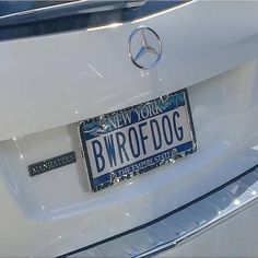 a license plate on the back of a white mercedes benz car with new york written on it